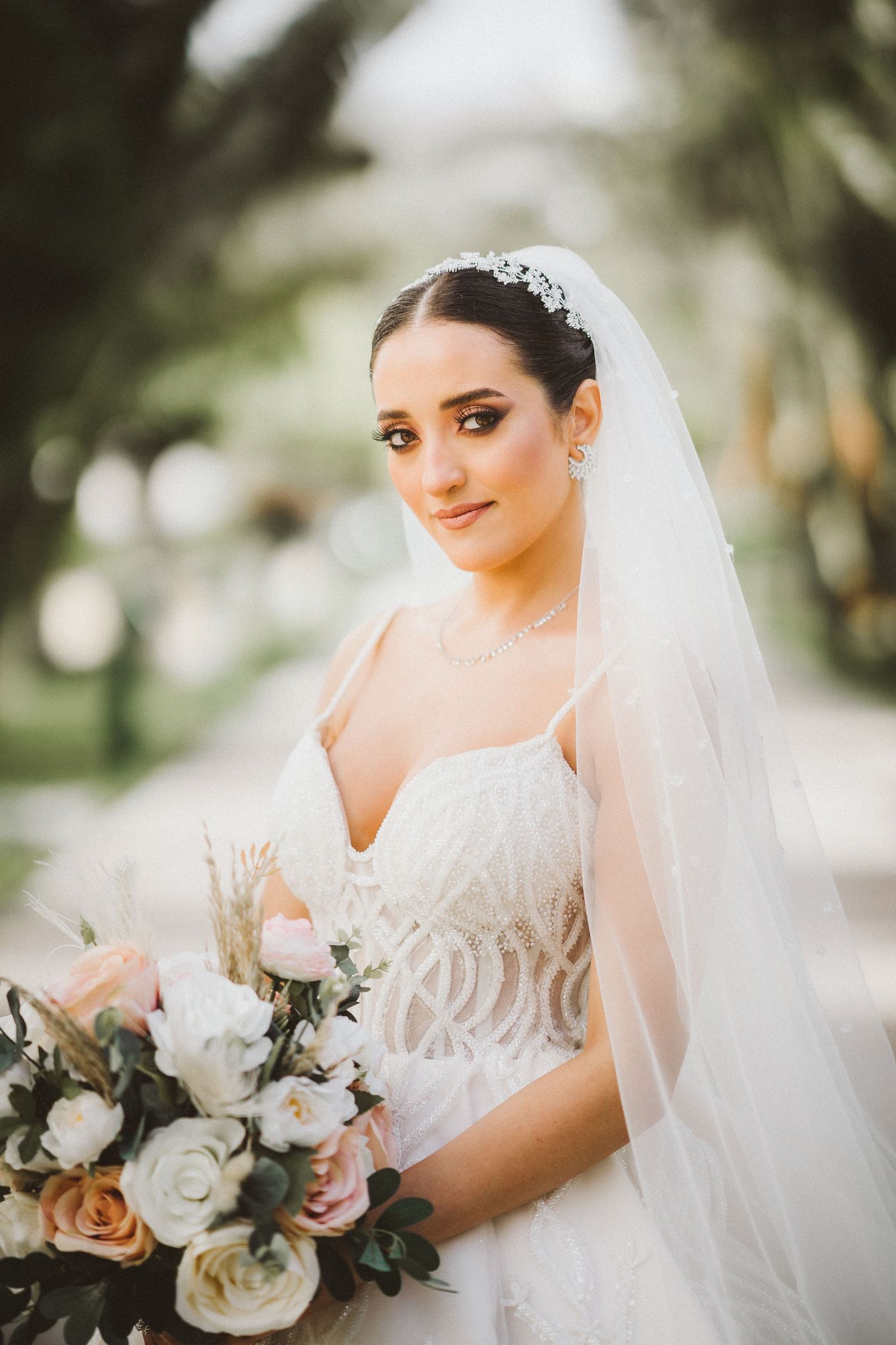 Elegant bridal portraits featuring a lace wedding dress and white floral bouquet.