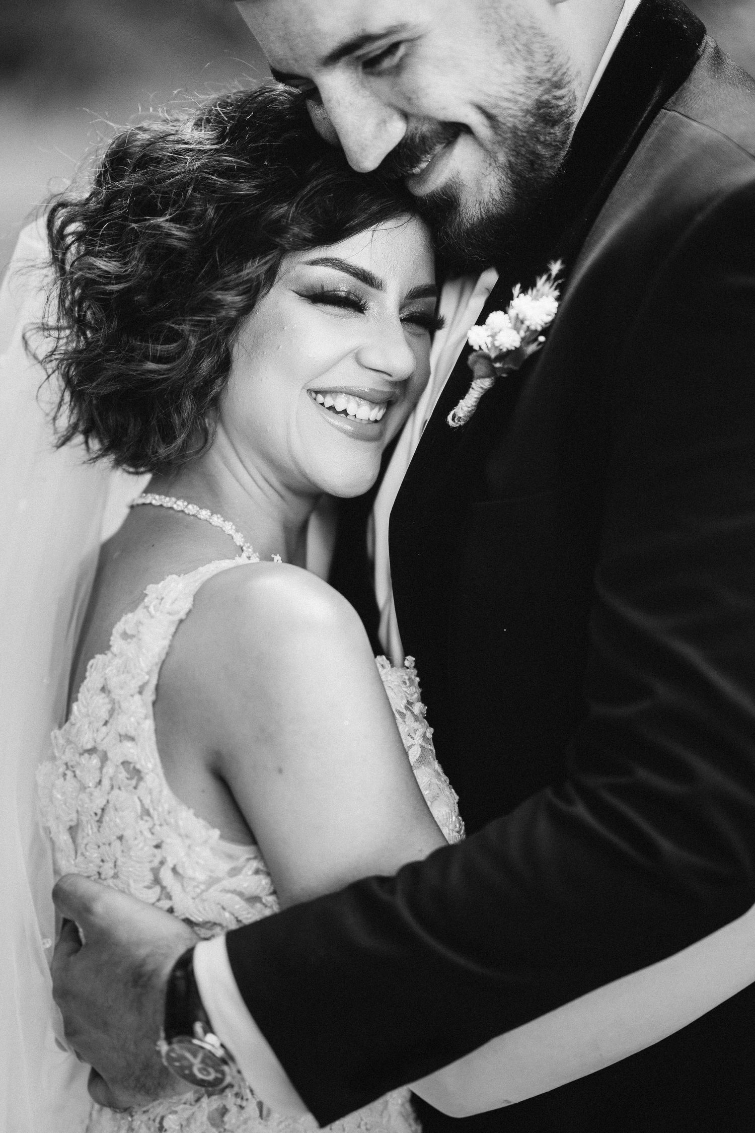 A tender black and white wedding portrait capturing an intimate embrace.