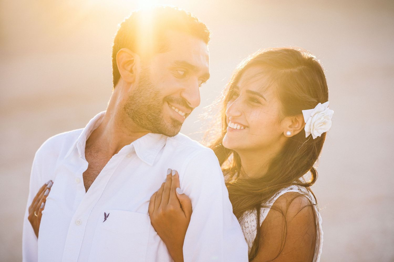 Warm sunset light illuminates a romantic couple's moment.
