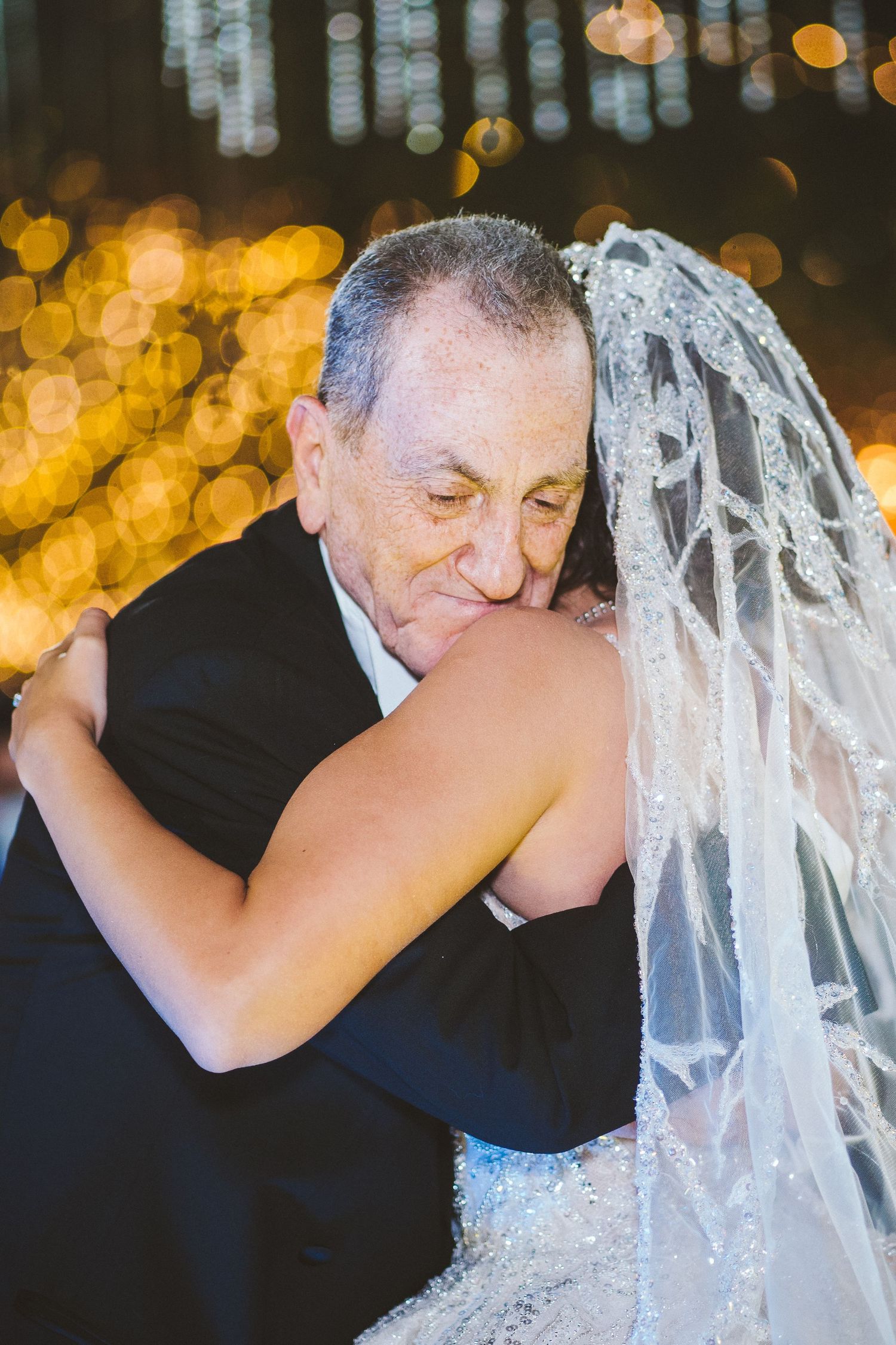 Emotional dance moment with bokeh lights creating a romantic atmosphere.