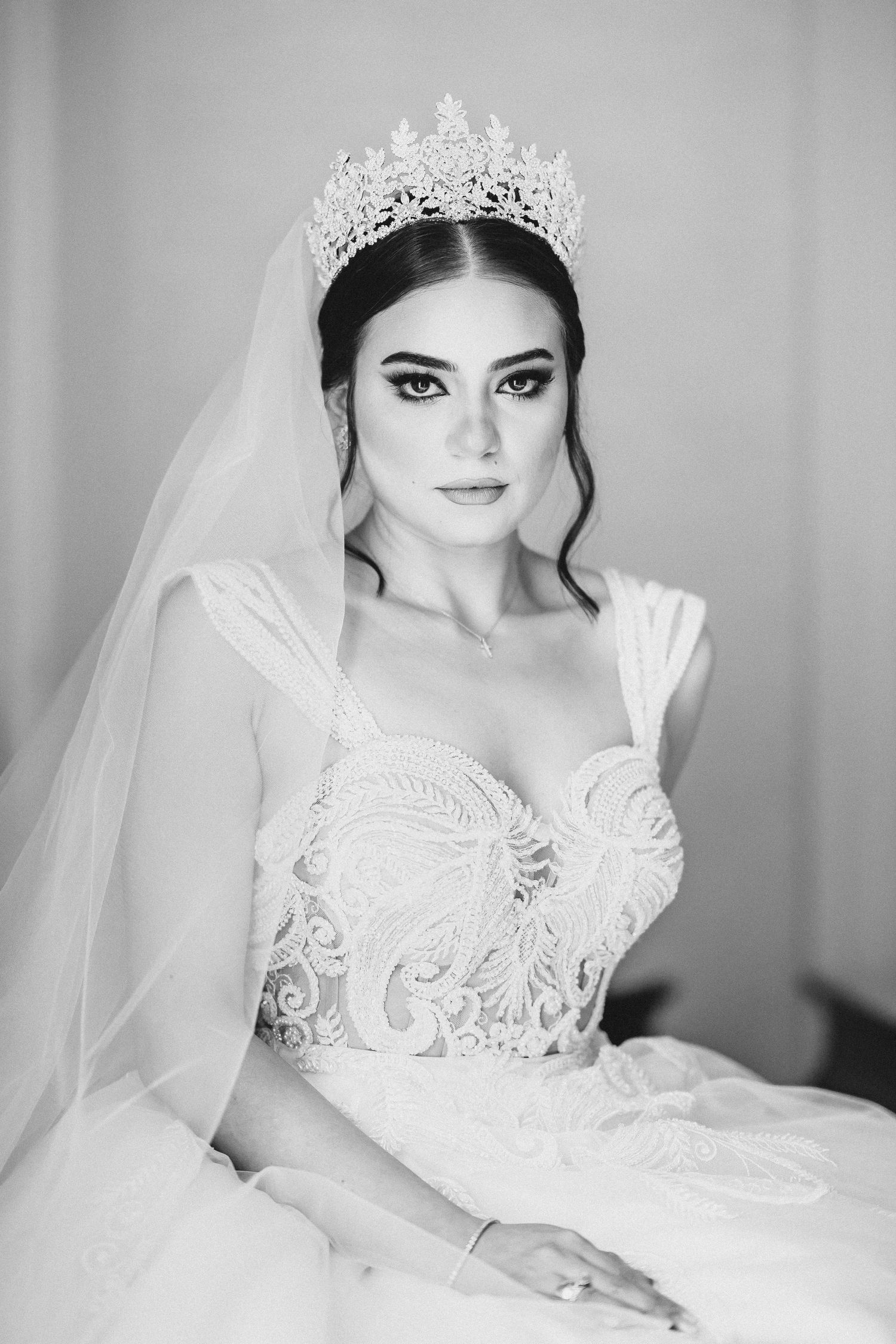 Classic bridal portrait in black and white featuring an ornate crown and veil.