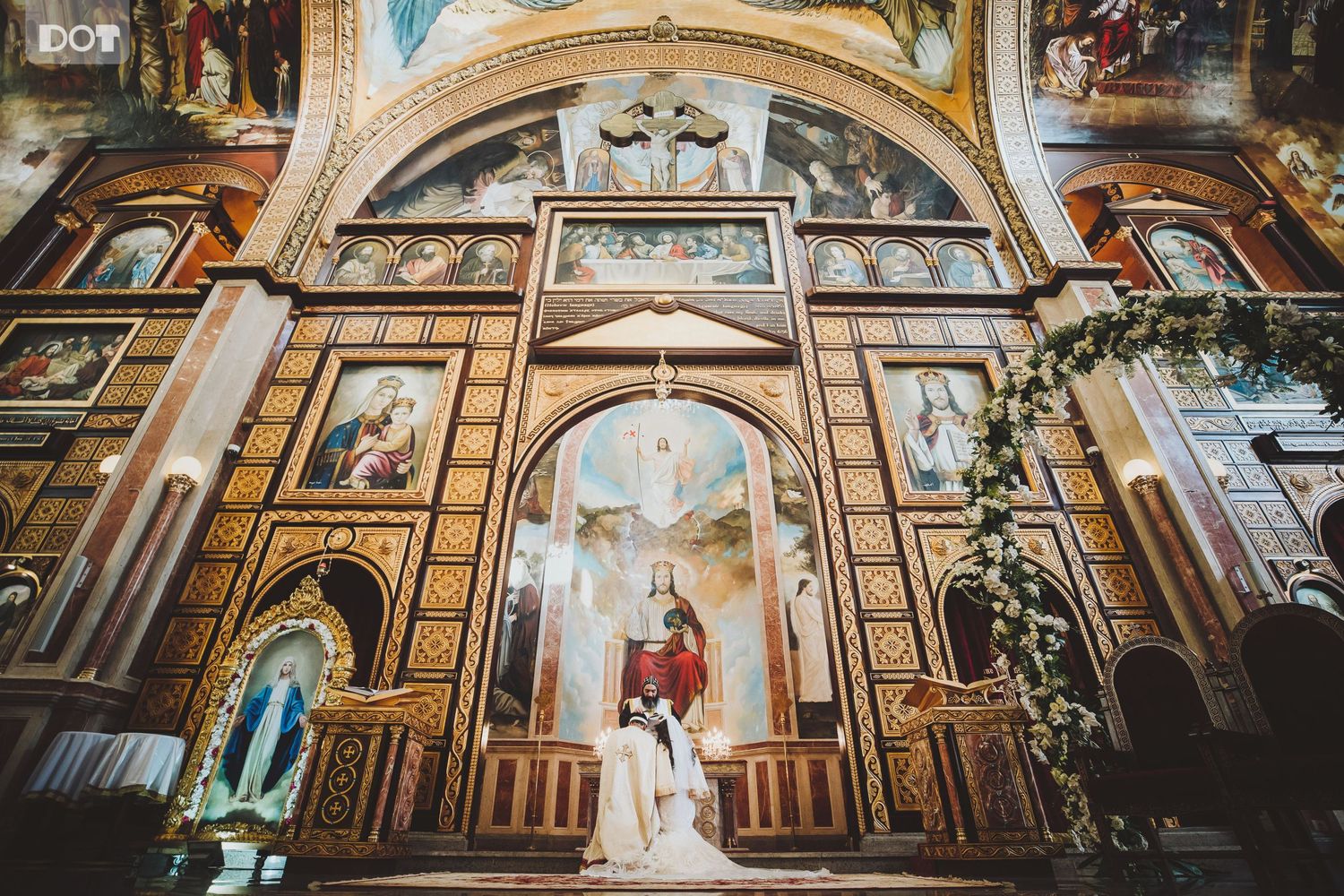 Ornate cathedral ceiling with detailed religious artwork and architectural elements.