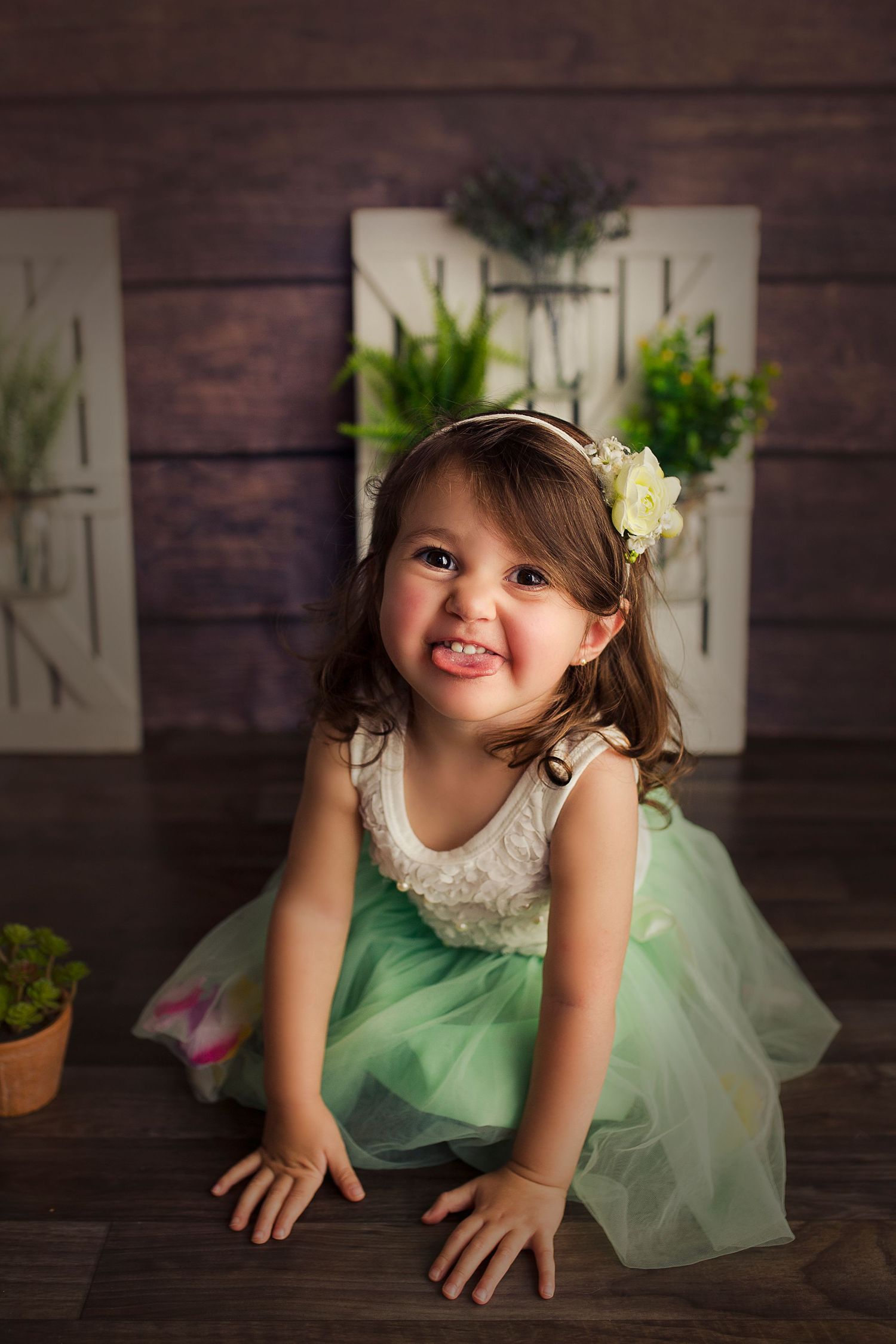 toddler girl sticking tongue out with tulle dress