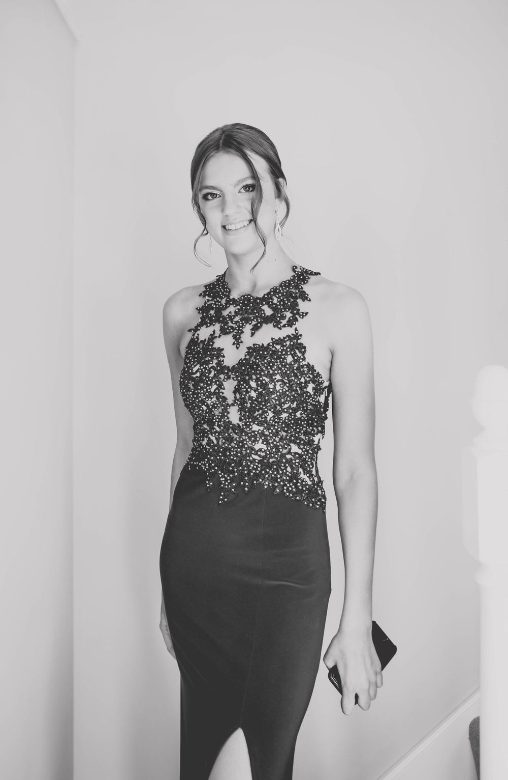 Elegant black and white portrait showing a formal gown with detailed lace bodice and fitted silhouette.