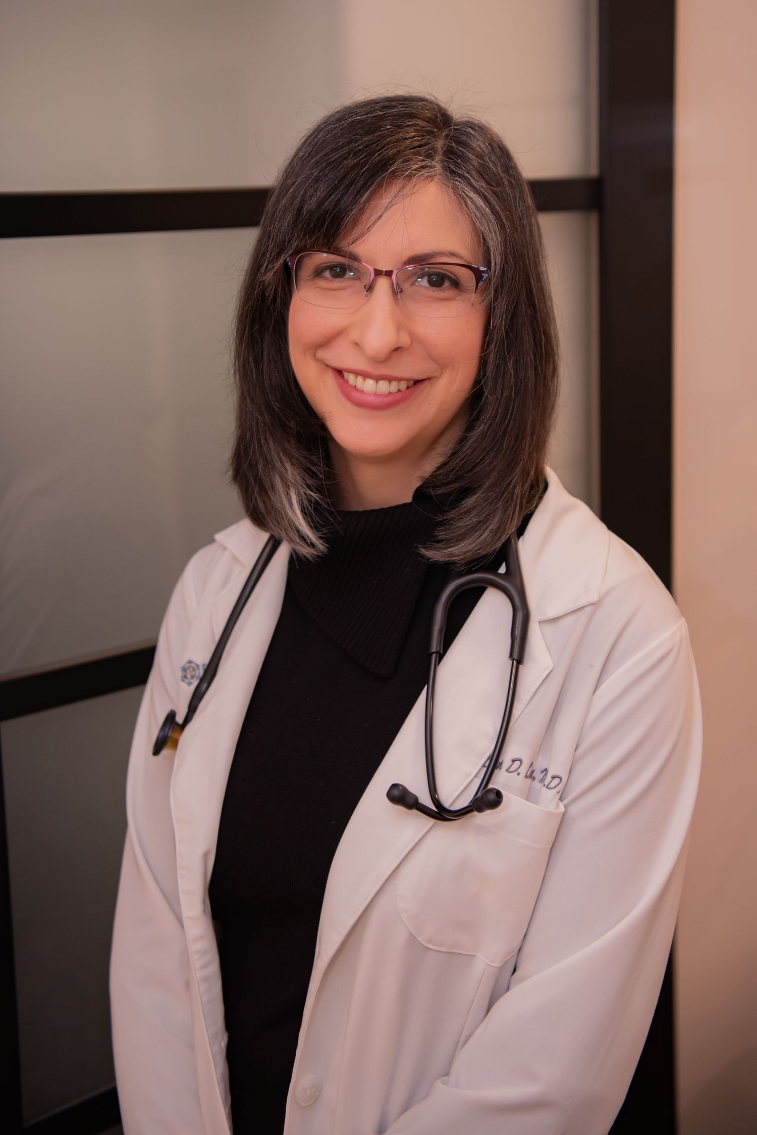 woman physician in white coat with stethoscope kirsten lin