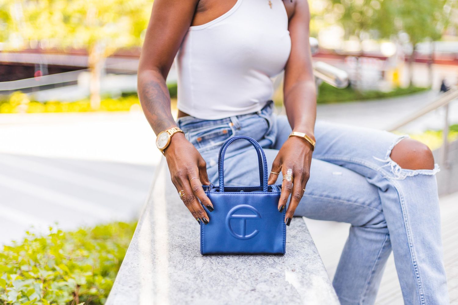 close up of black woman with small blue telfar bag in chicago by CLW Photography