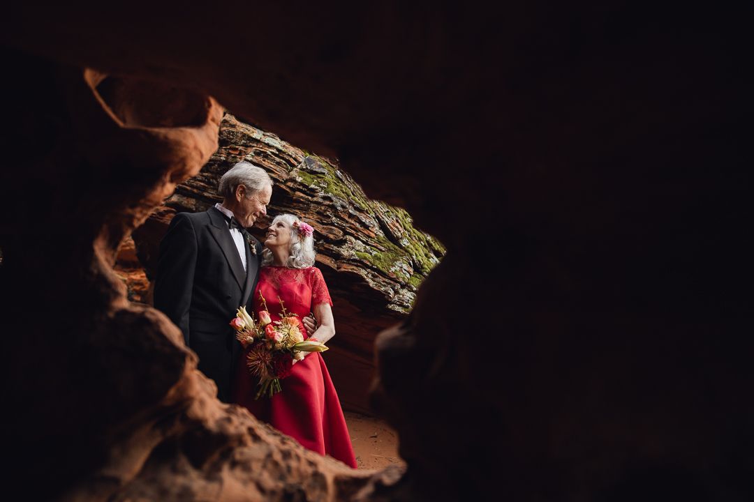 Cute couple in a red rock window renewing vows.