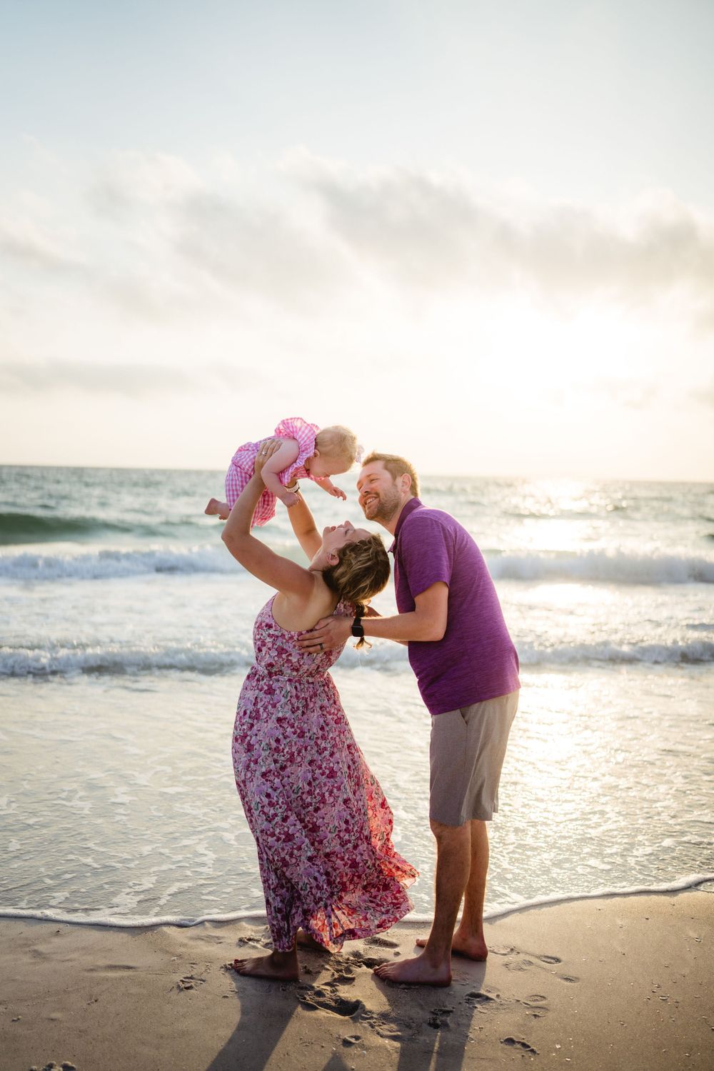 A joyful family moment captured at sunset on the beach.