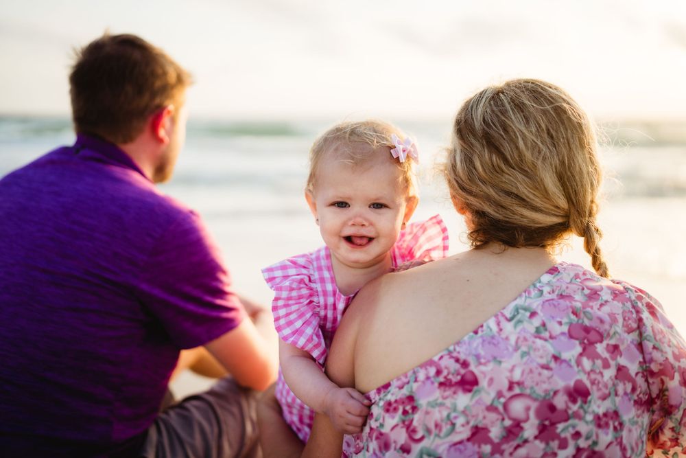 A happy family moment shared on the beach during golden hour.