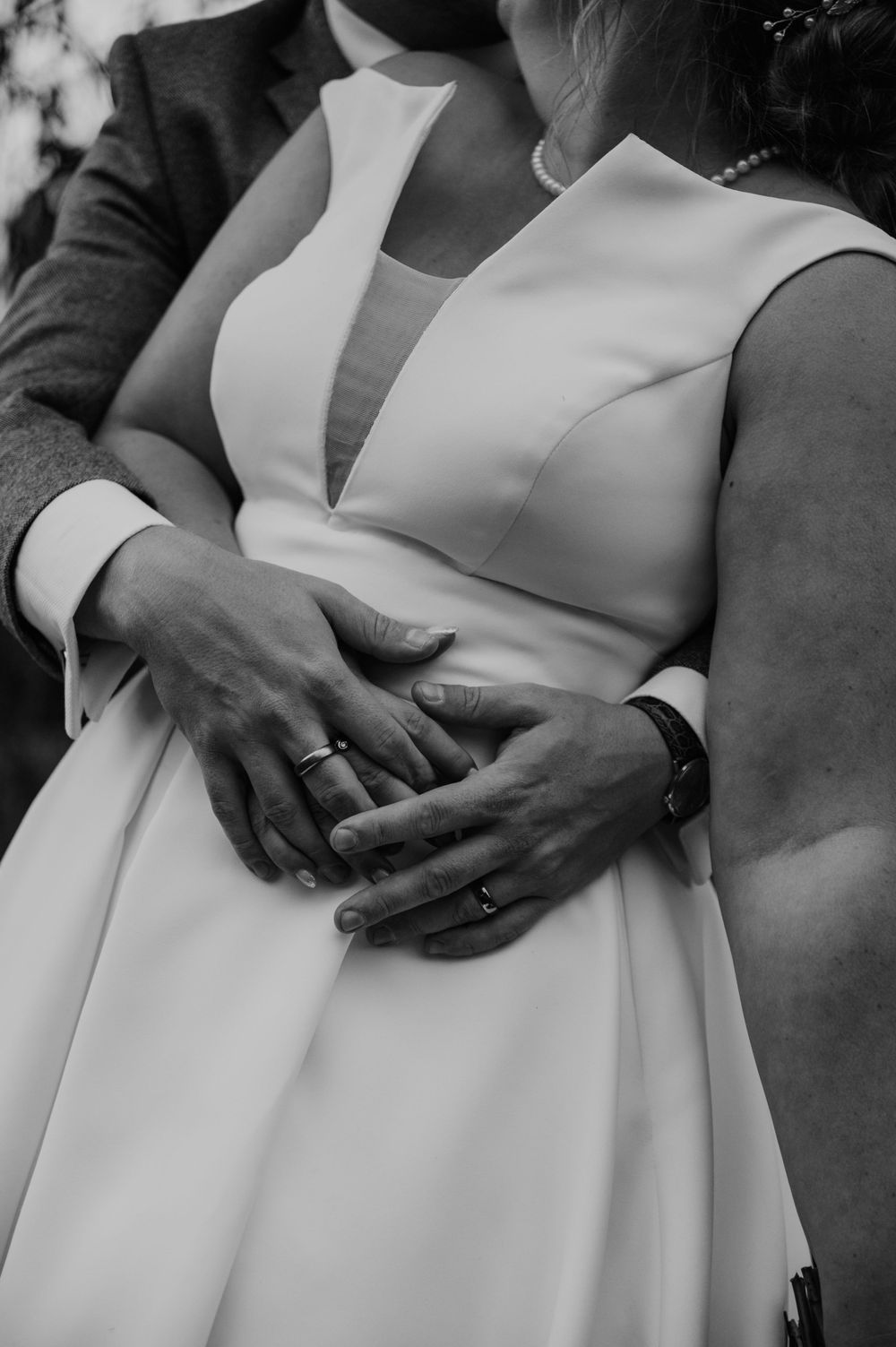 Intertwined wedding couple hands in black and white at Hareston Manor