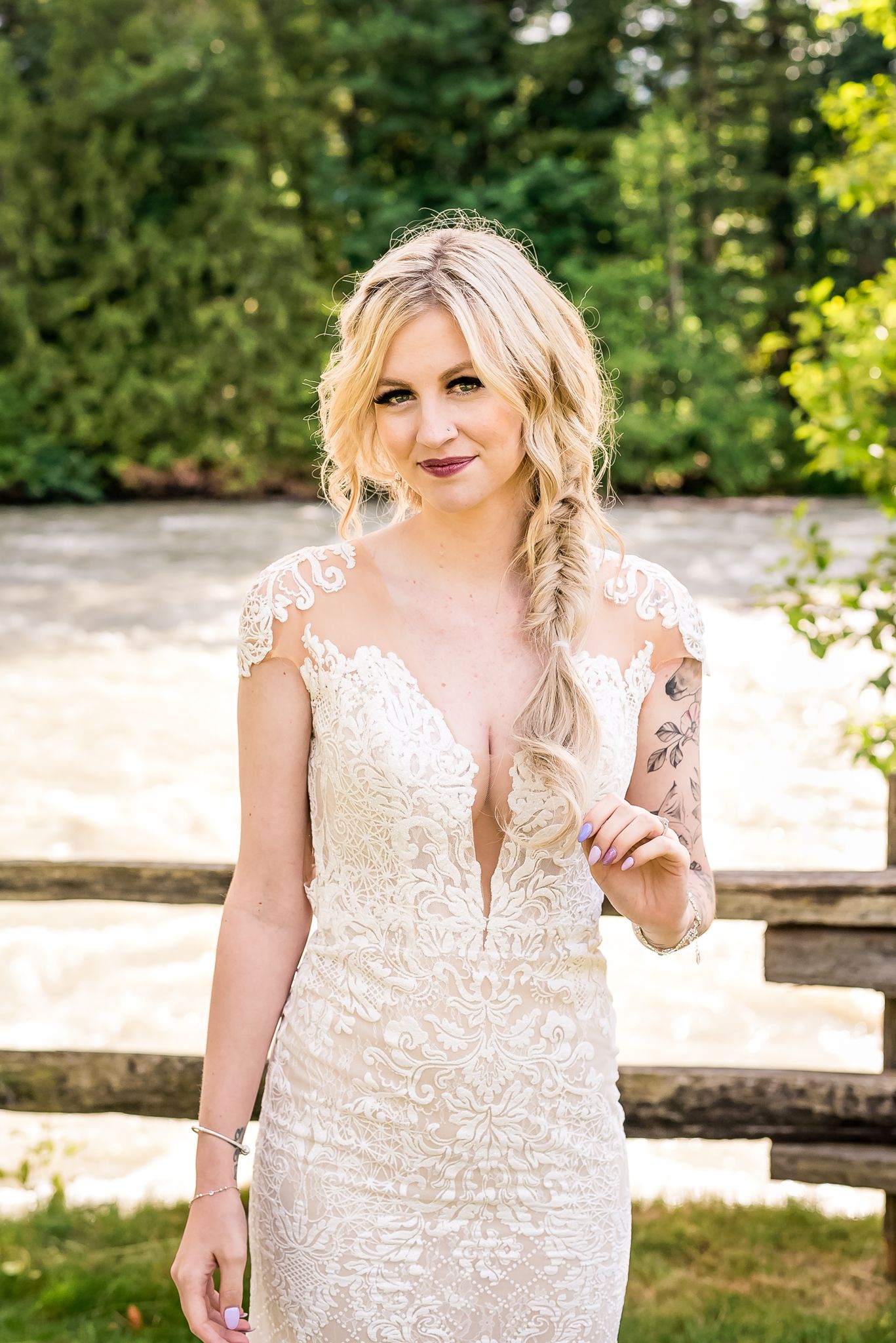 Gorgeous bride by the river on a sunny day at Hope Golf Course. Photo by Fraser Valley photographer, Kari Mills.