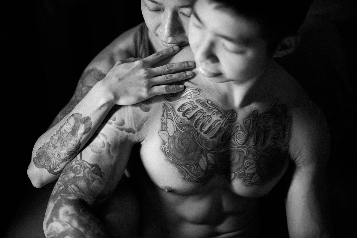 couple with tattoo hugging each other