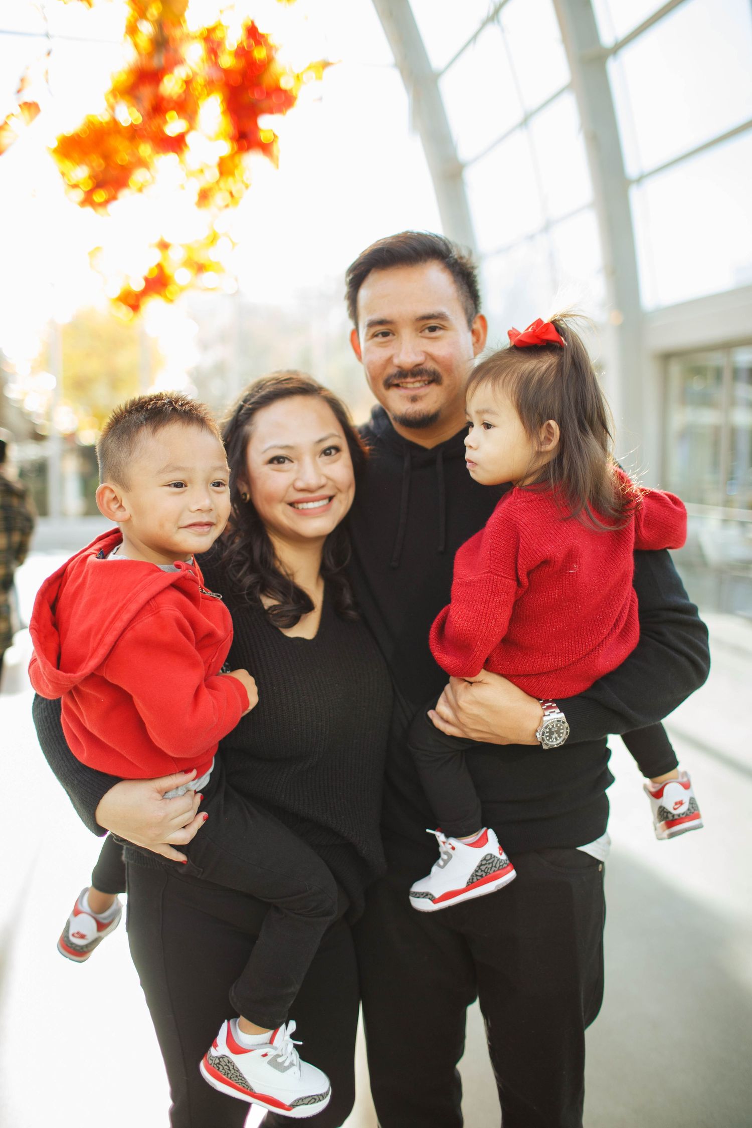 Seattle family photographer: a family of four stand together in the cCihuly garden and glass museum at the Seattle center