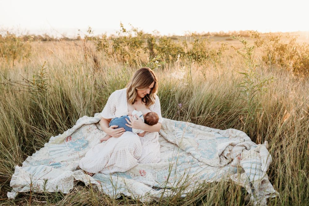 A peaceful moment on a blanket in a sun-drenched field.