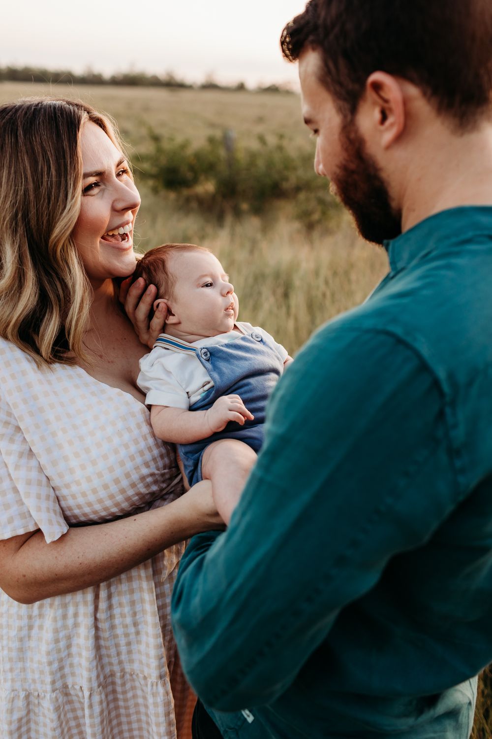 Intimate family portraits showing loving embraces in a natural outdoor setting at sunset.