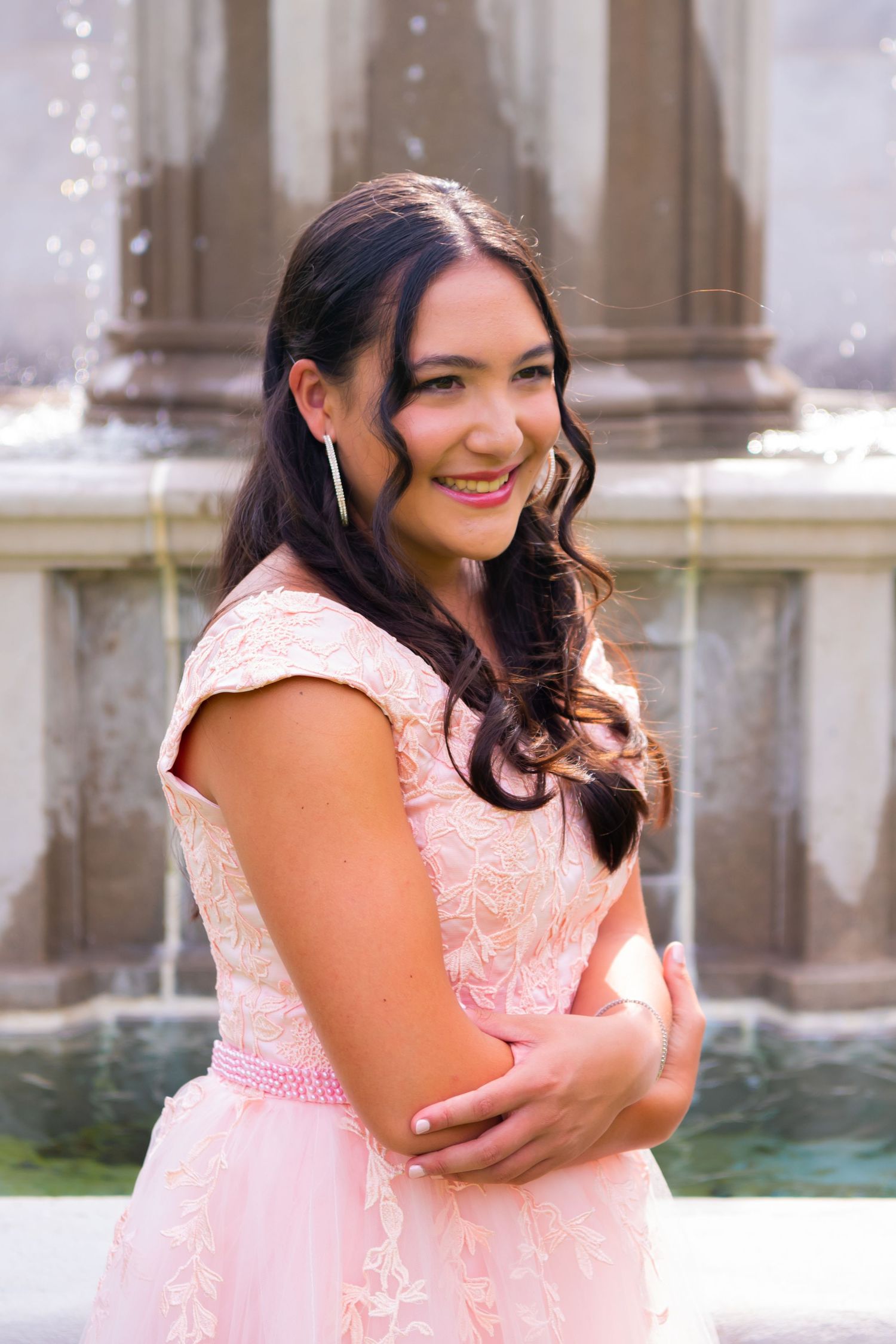 girl in pink gown in front on fountain at mellon park