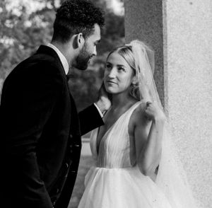 Intimate black and white portrait of newlyweds sharing a tender moment.