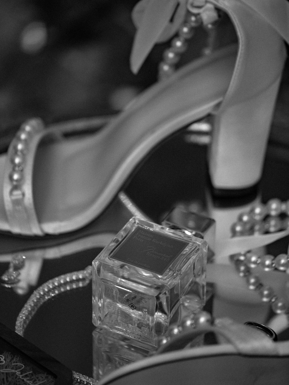 Crystal perfume bottles and elegant bridal shoes with rhinestone details.