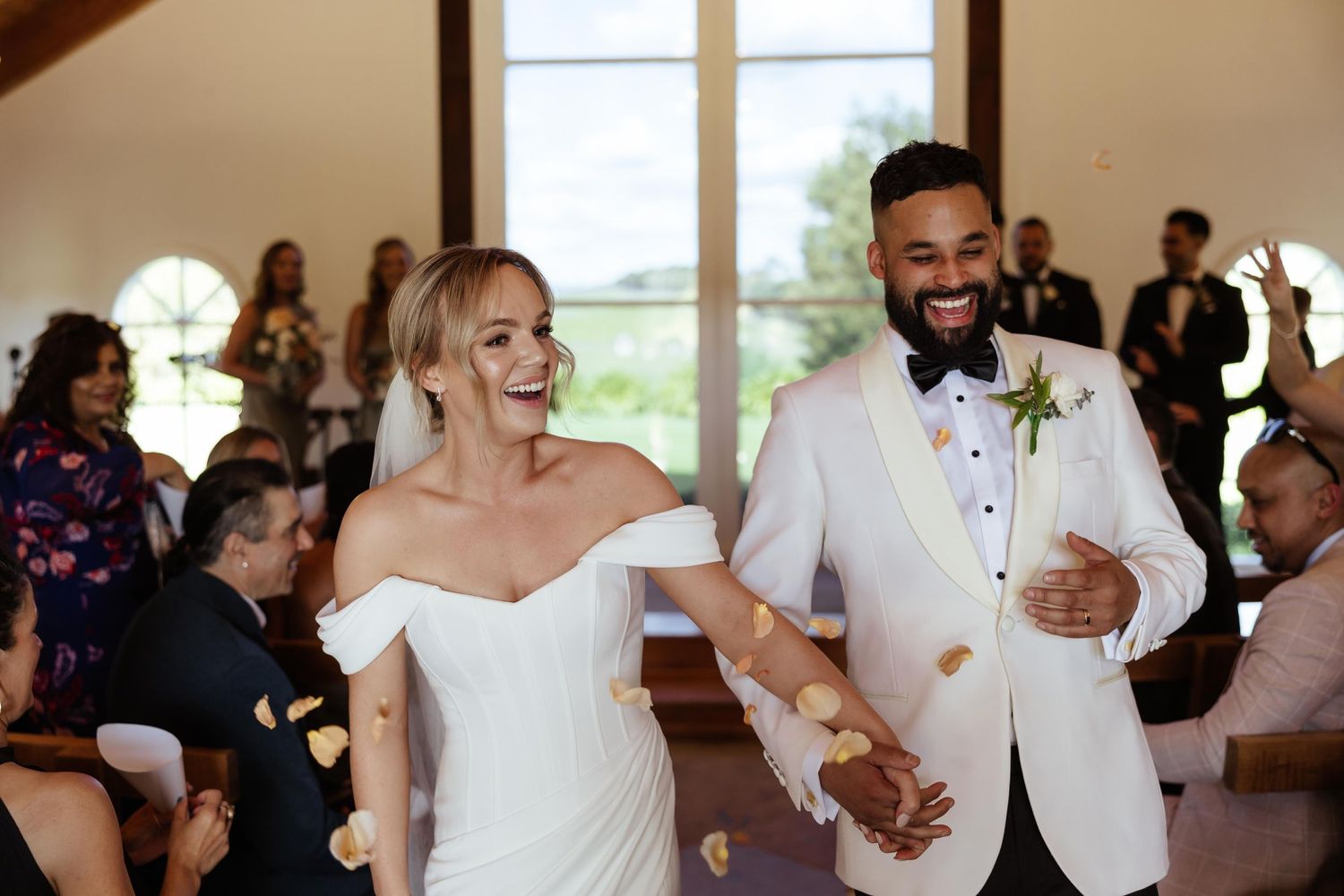 Wedding celebration captured in a rustic indoor venue with natural lighting.