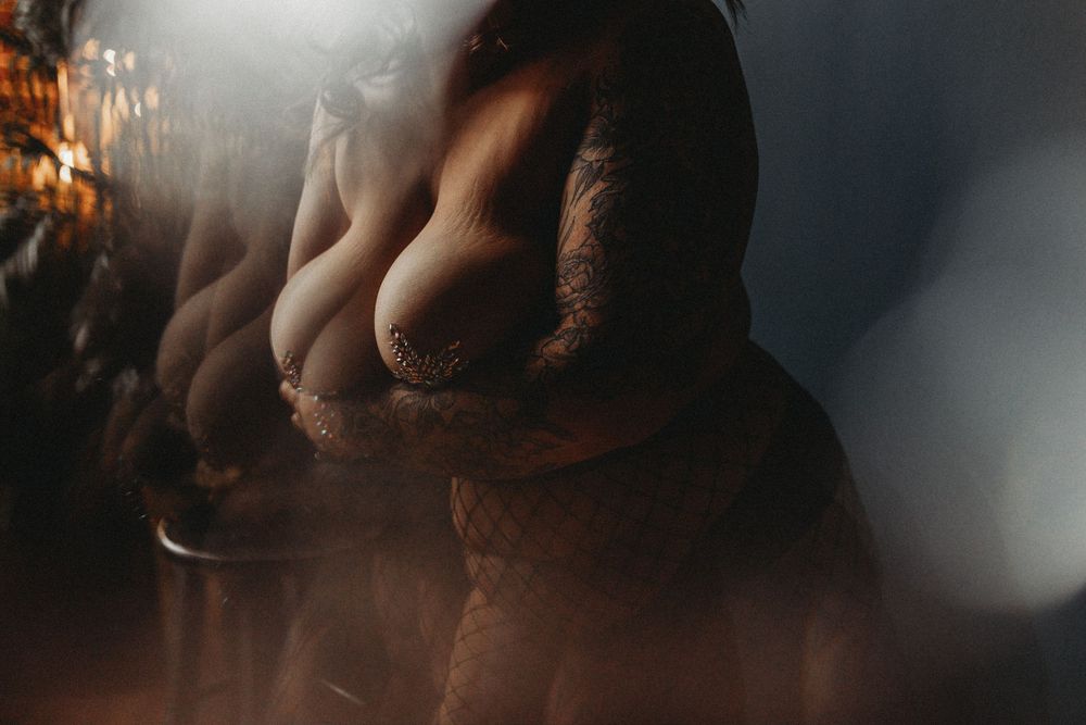 Abstract artistic nude photography with soft focus and light effects.