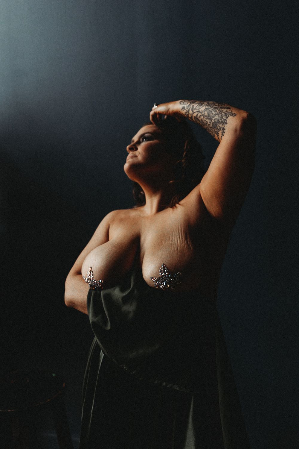 Dramatic portrait with dark background and directional lighting.