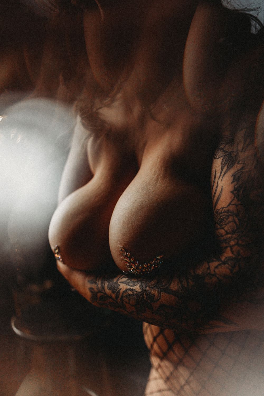 Intimate boudoir photography with lace details and moody lighting effects.