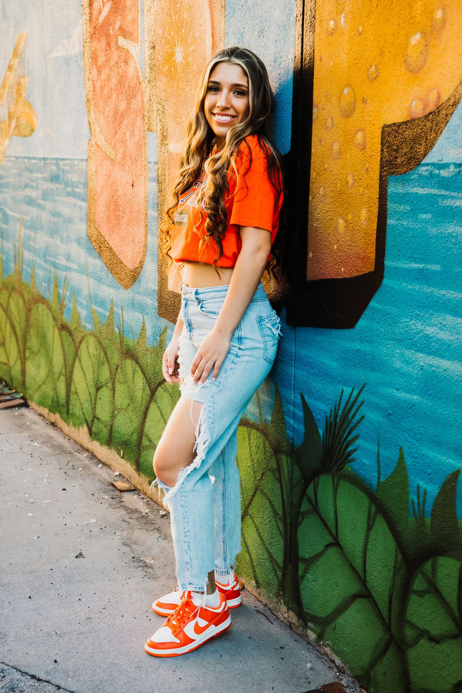 Outdoor Senior Portrait Session Downtown St. Pete, FL; Senior photos, teen leaning on mural
