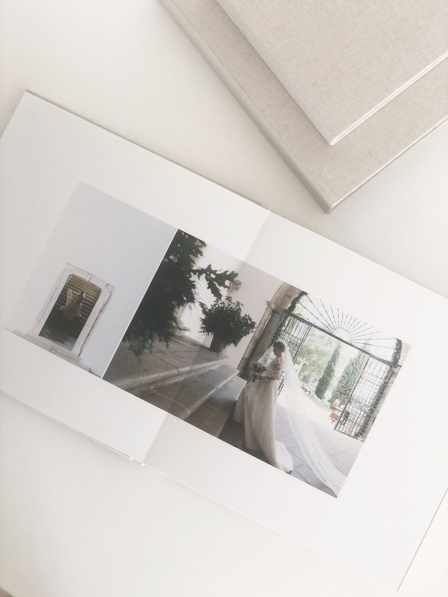 Photo album page showing a wedding photo spread with elegant white matting and minimal design.