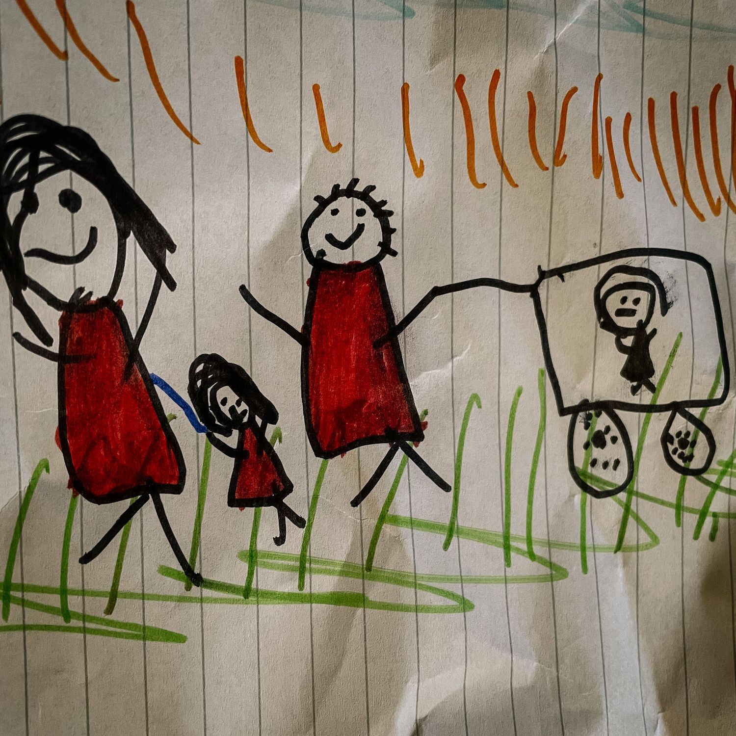 A child's drawing in red shows stick figures of a family enjoying time outdoors together.