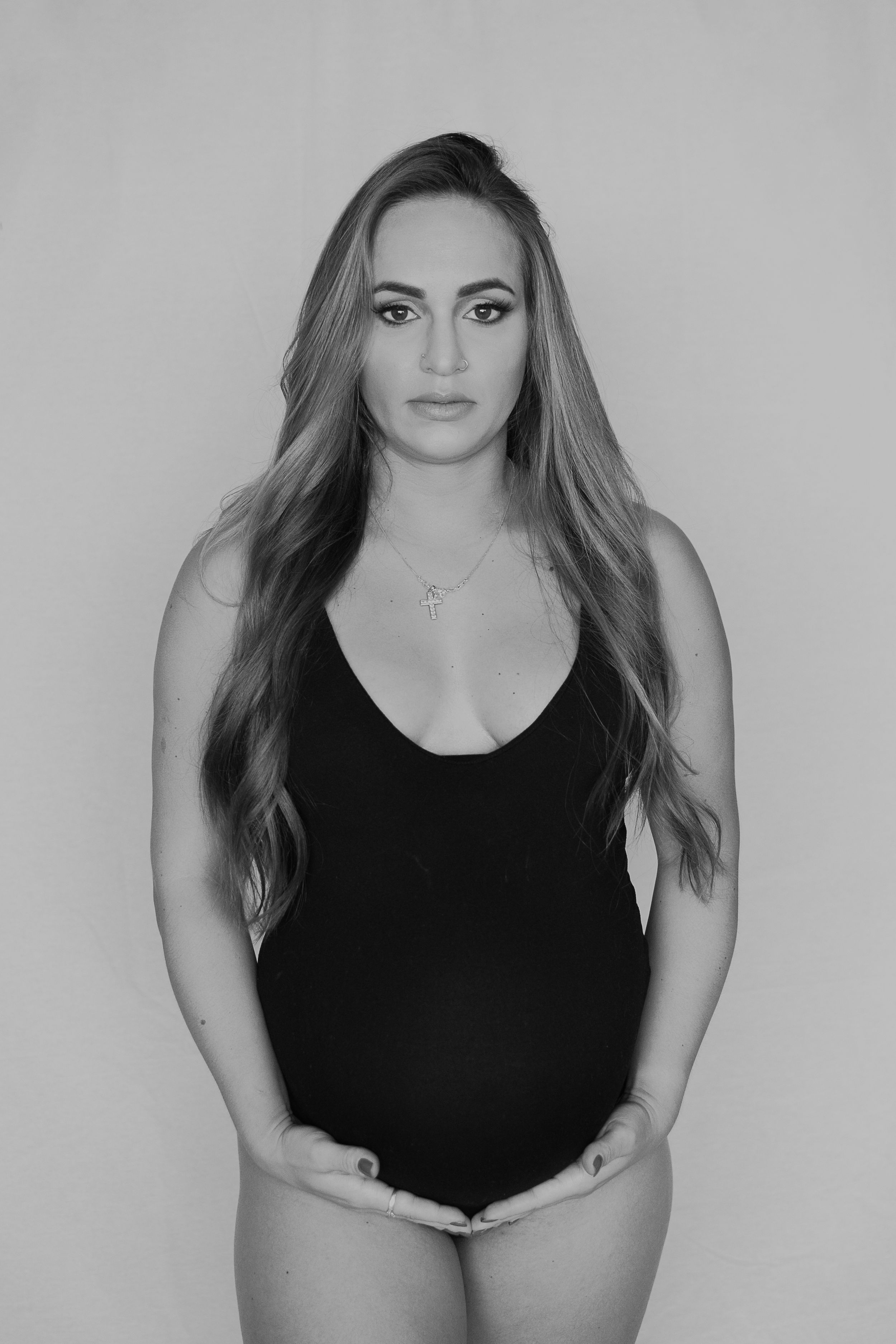 Black and white portrait series featuring a woman in a black tank top.