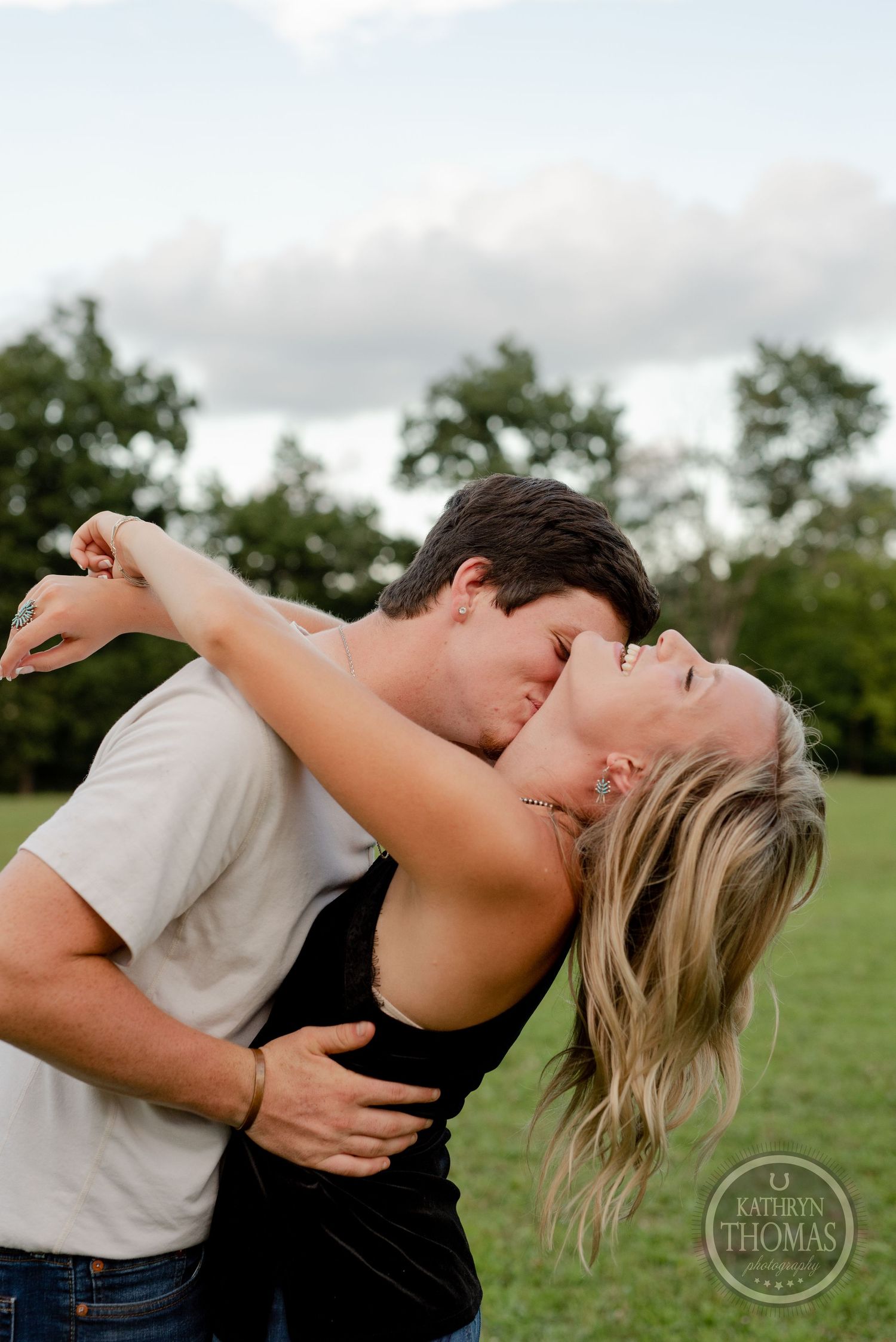 Romantic dip pose captured during couple's outdoor photoshoot.