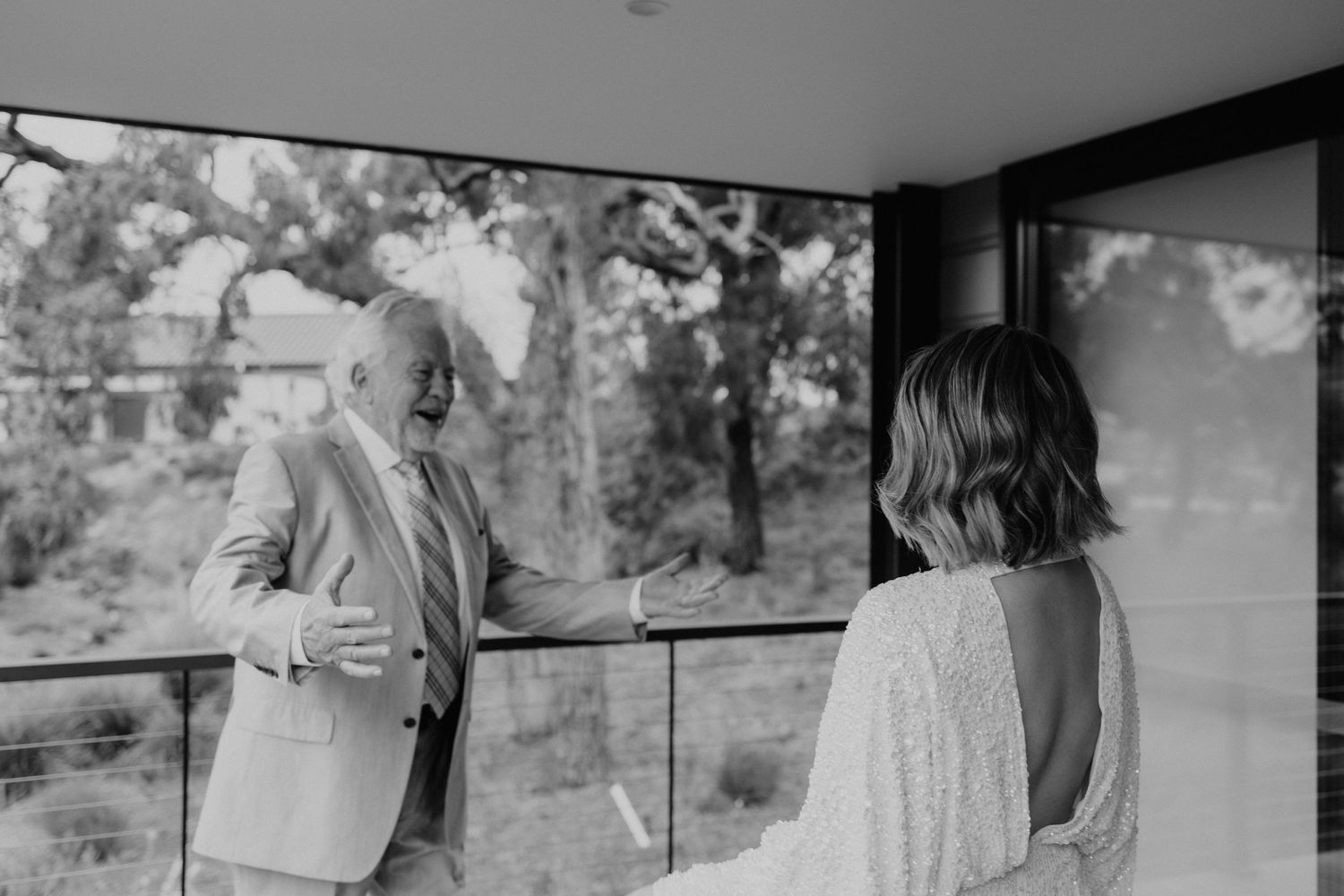Wedding couple shares intimate moments in modern architectural setting.