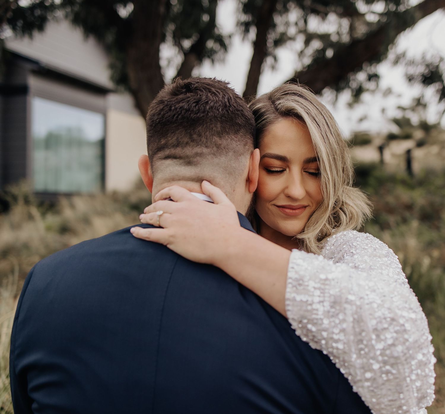 Romantic wedding portrait series showing tender embrace moments outdoors.