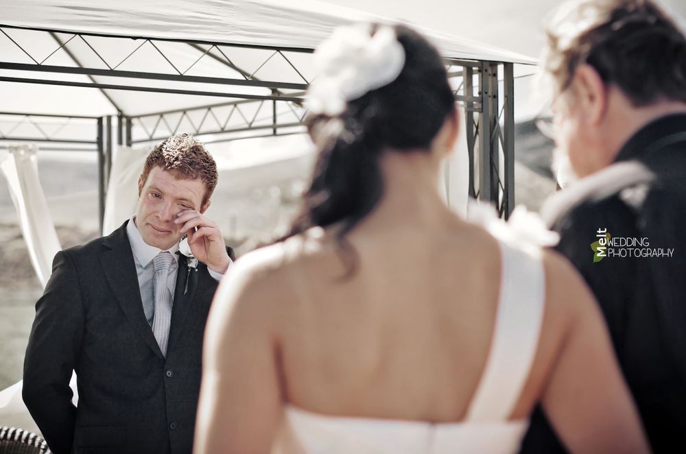 The groom having a moment when he first sees his bride