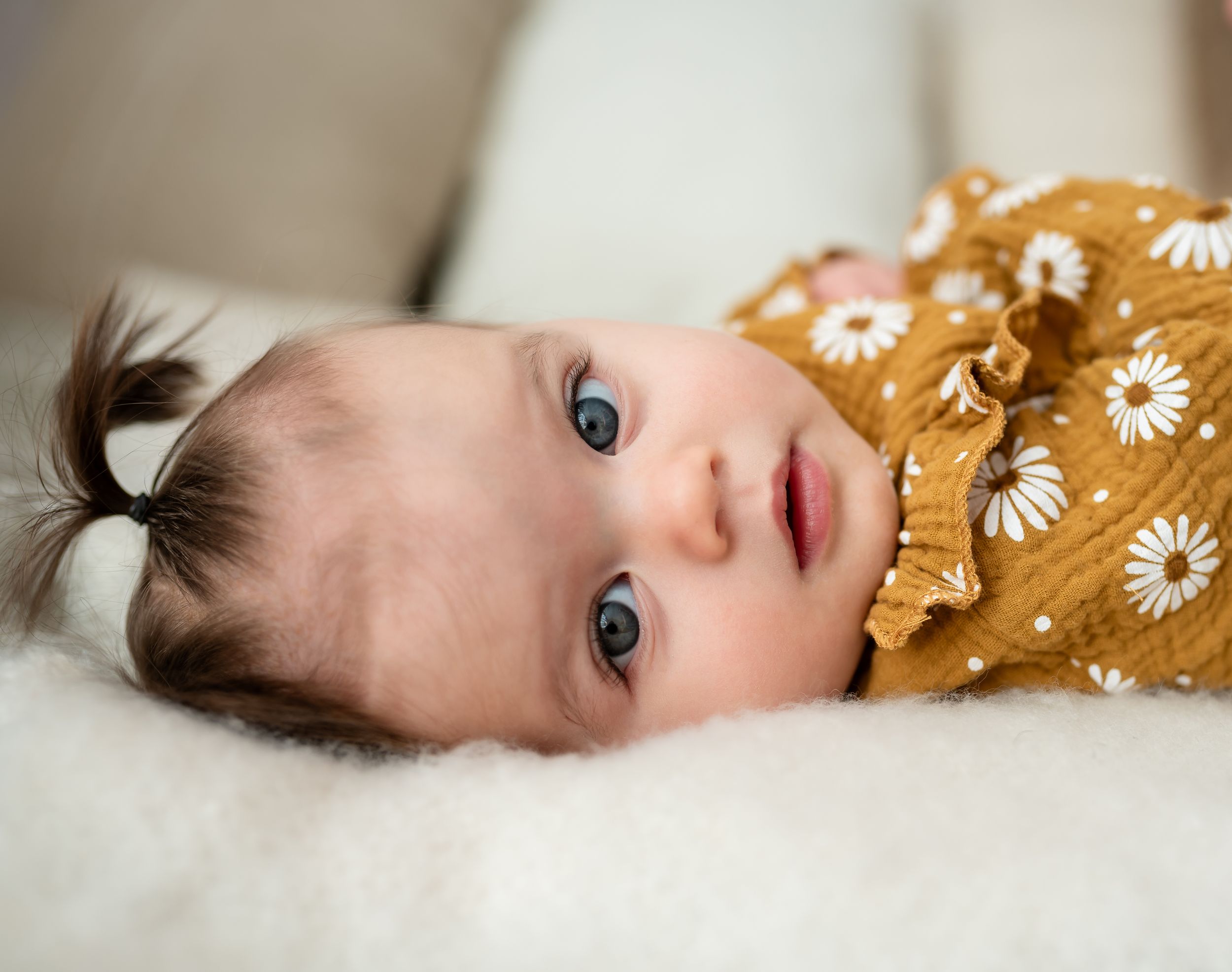 Close up of baby girl with big blue eyes