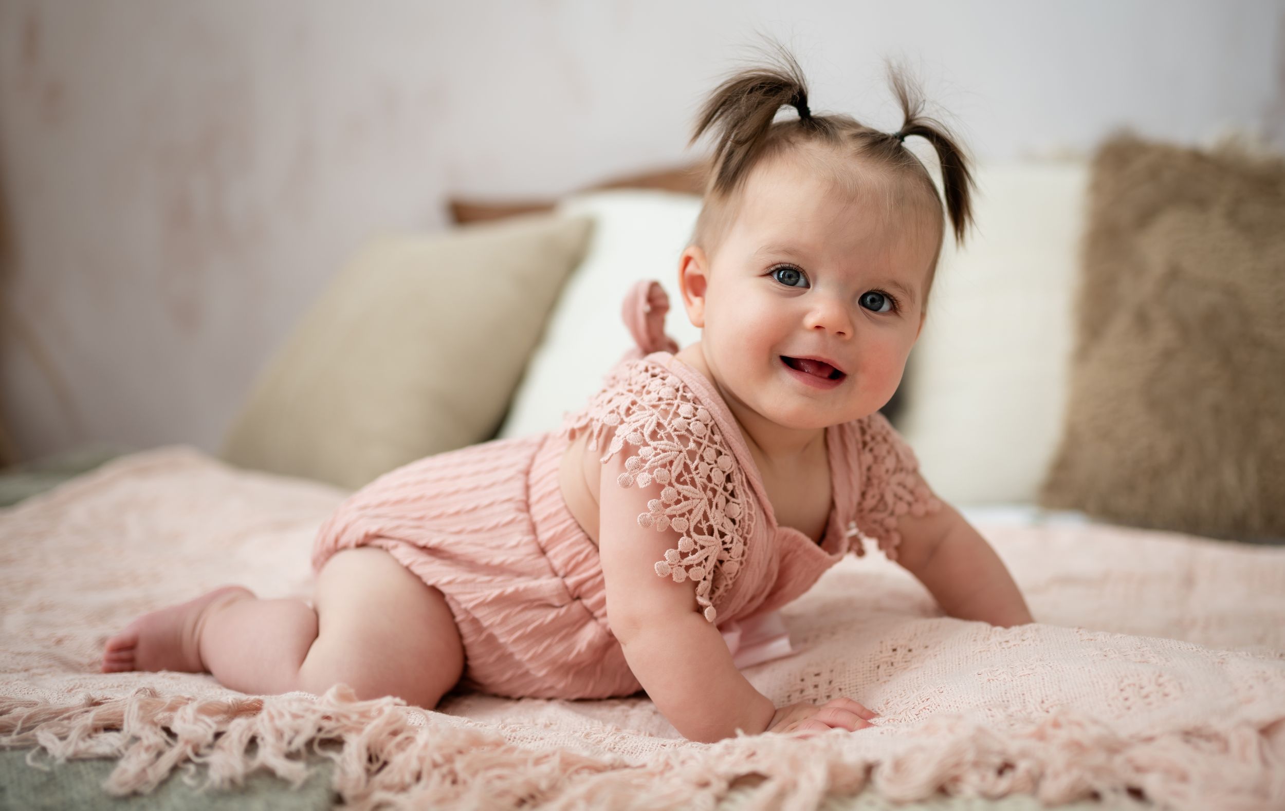 Adorable baby girl with pigtails crawling