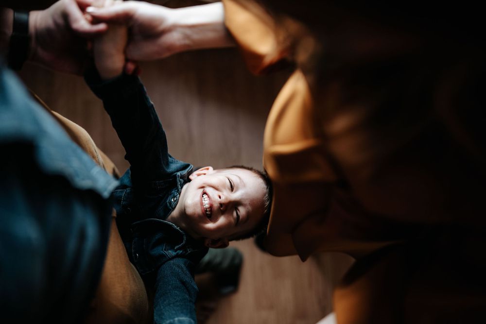 A playful moment captured as someone spins around in a dance-like motion indoors.