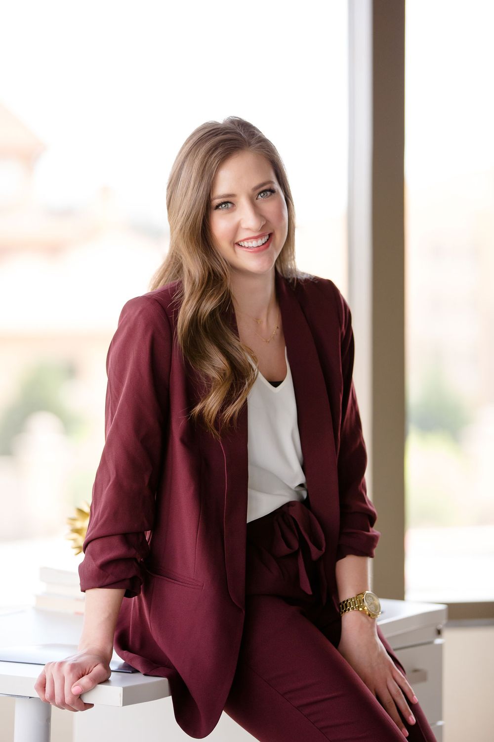 professional woman leaning against her work desk portrait
