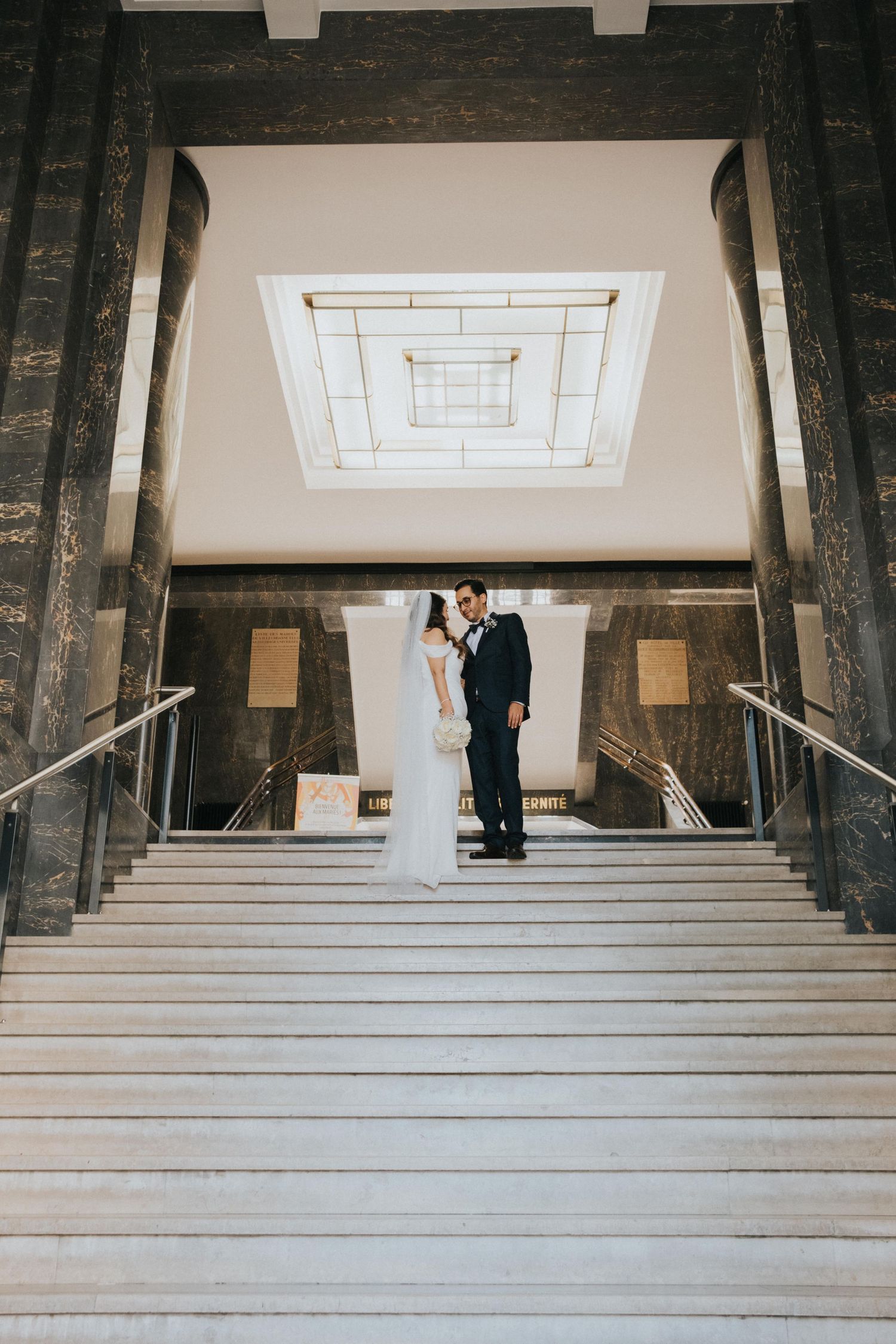 international wedding, couple standing at the stairs, at Lyon's mairie