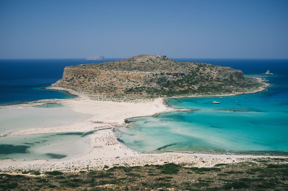 Stunning lagoon with crystal clear turquoise waters surrounded by rocky coastline.