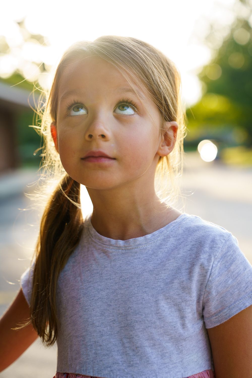 Young girl backlit and looking up and the sky in Columbus, Ohio by Jamie Macey Photography