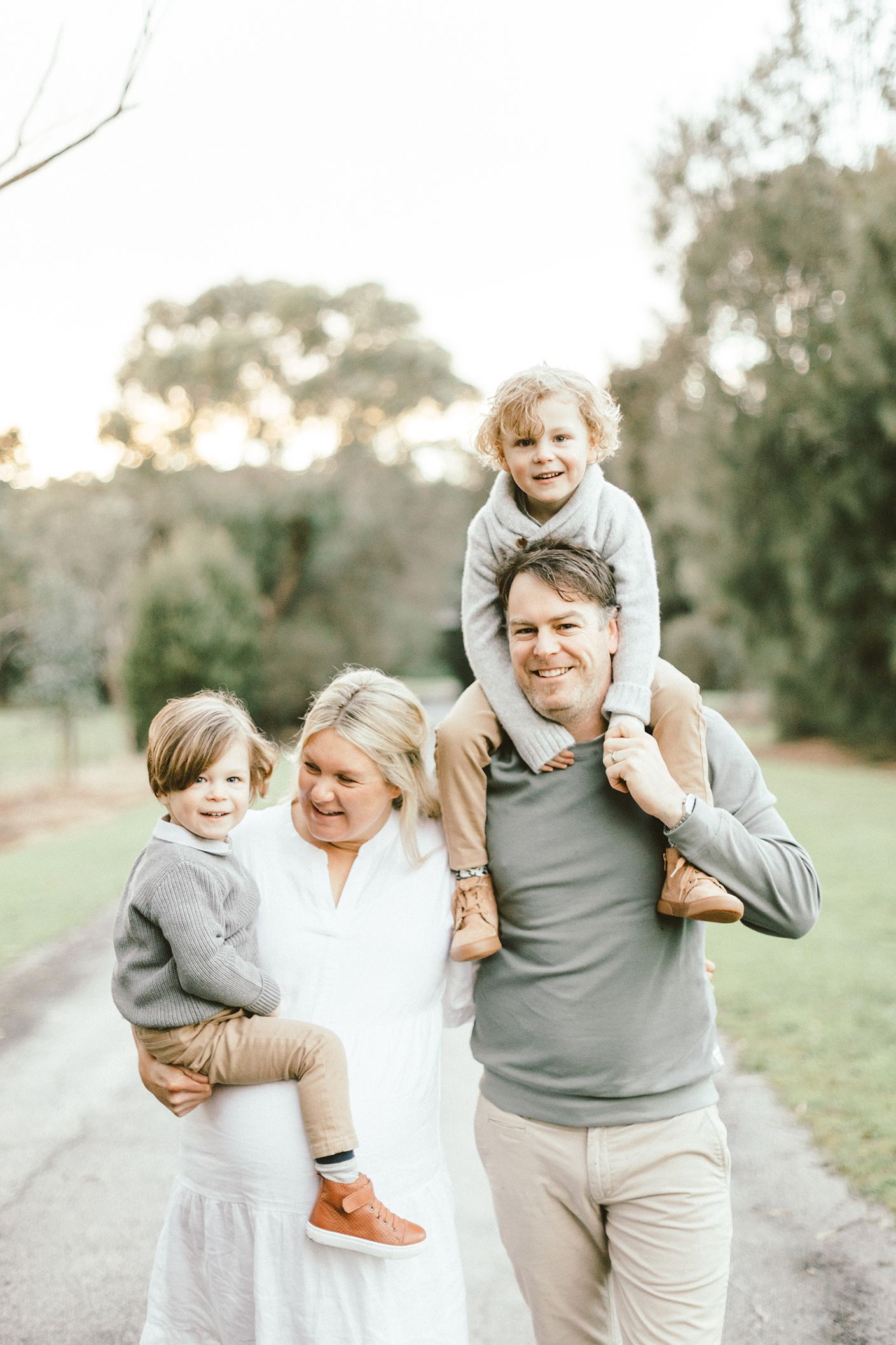 Candid family photos capture joyful moments of parents and children playing together outdoors.