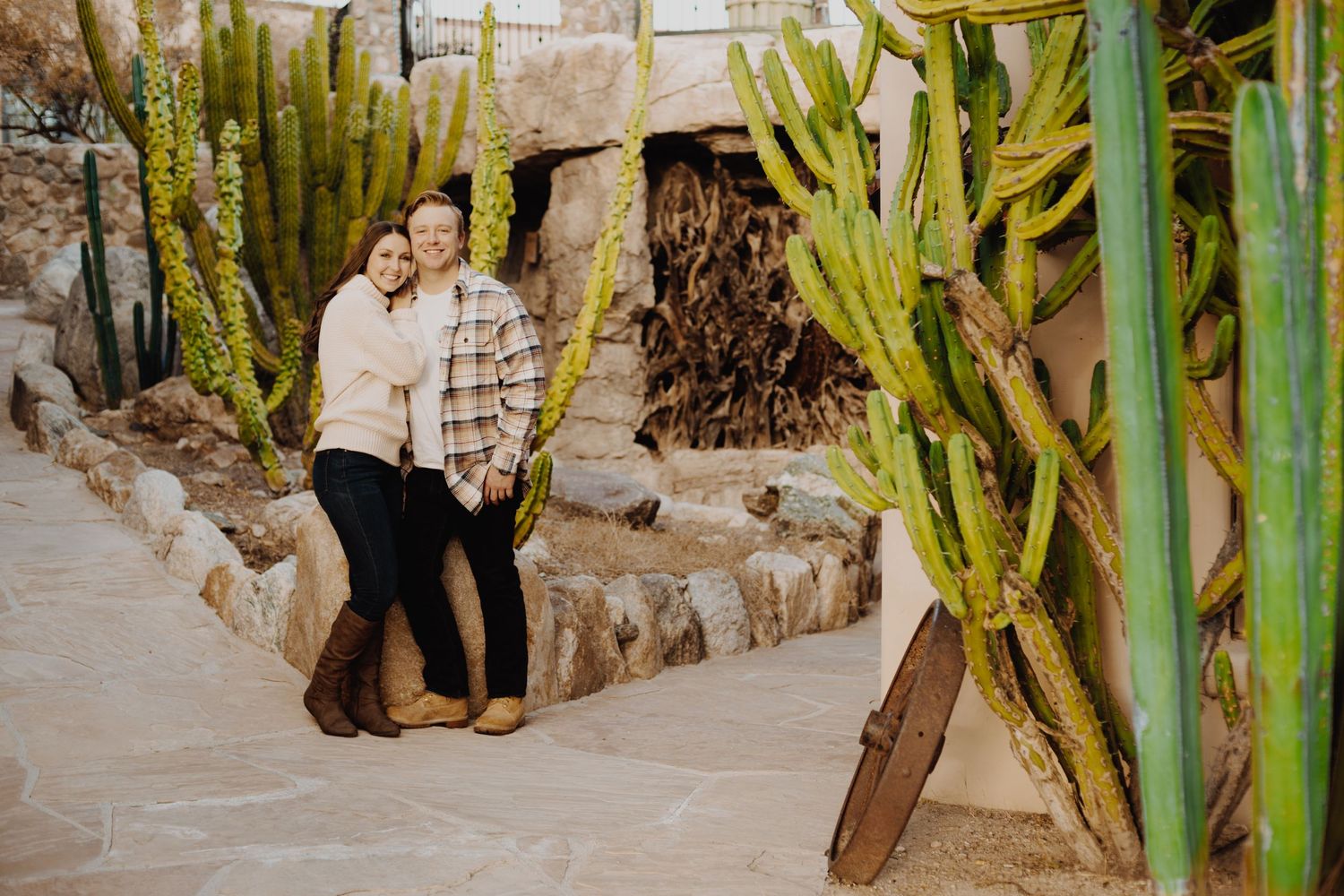 Romantic desert engagement photos with tall saguaro cacti at sunset.
