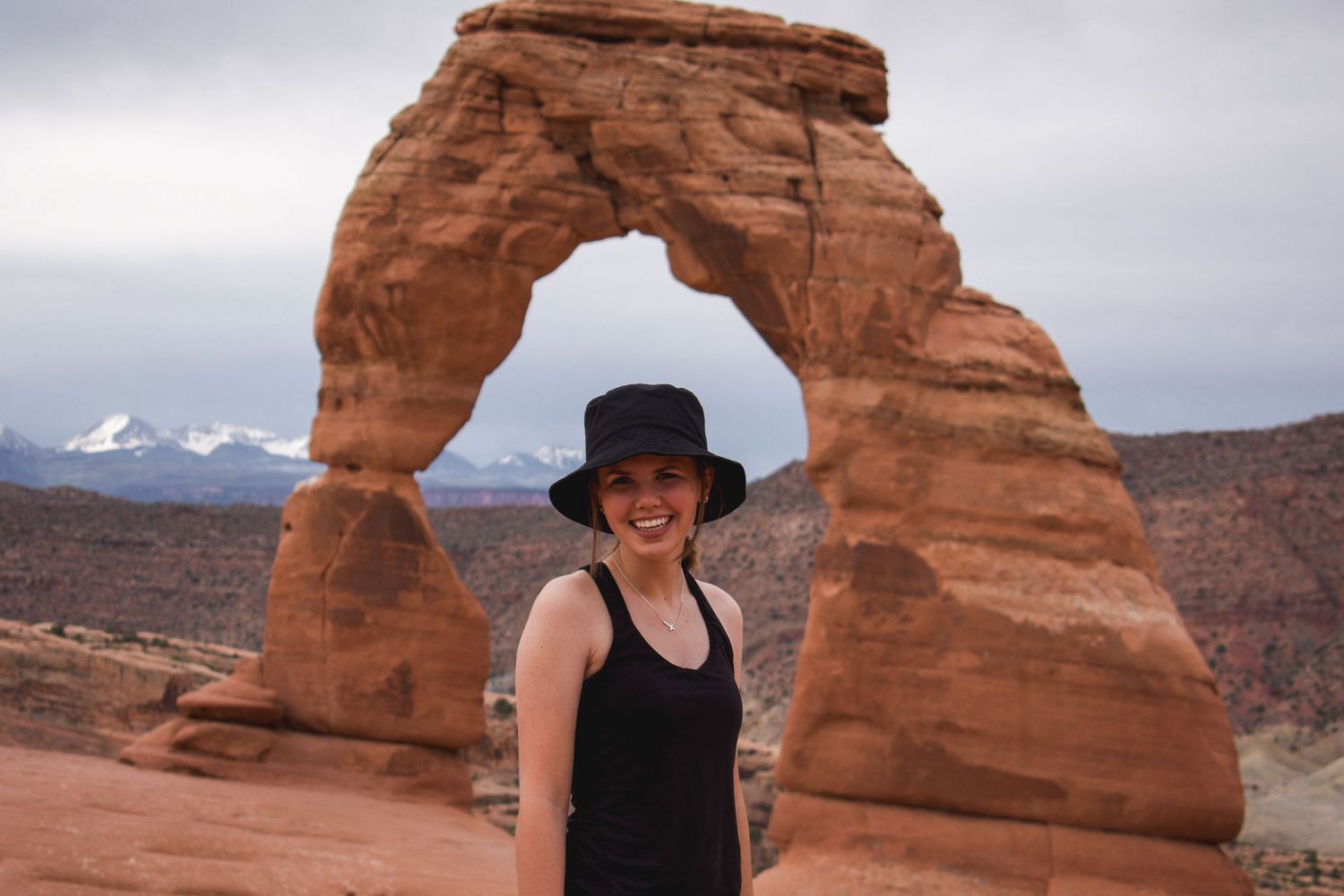 Woman in front of Delicate Arch