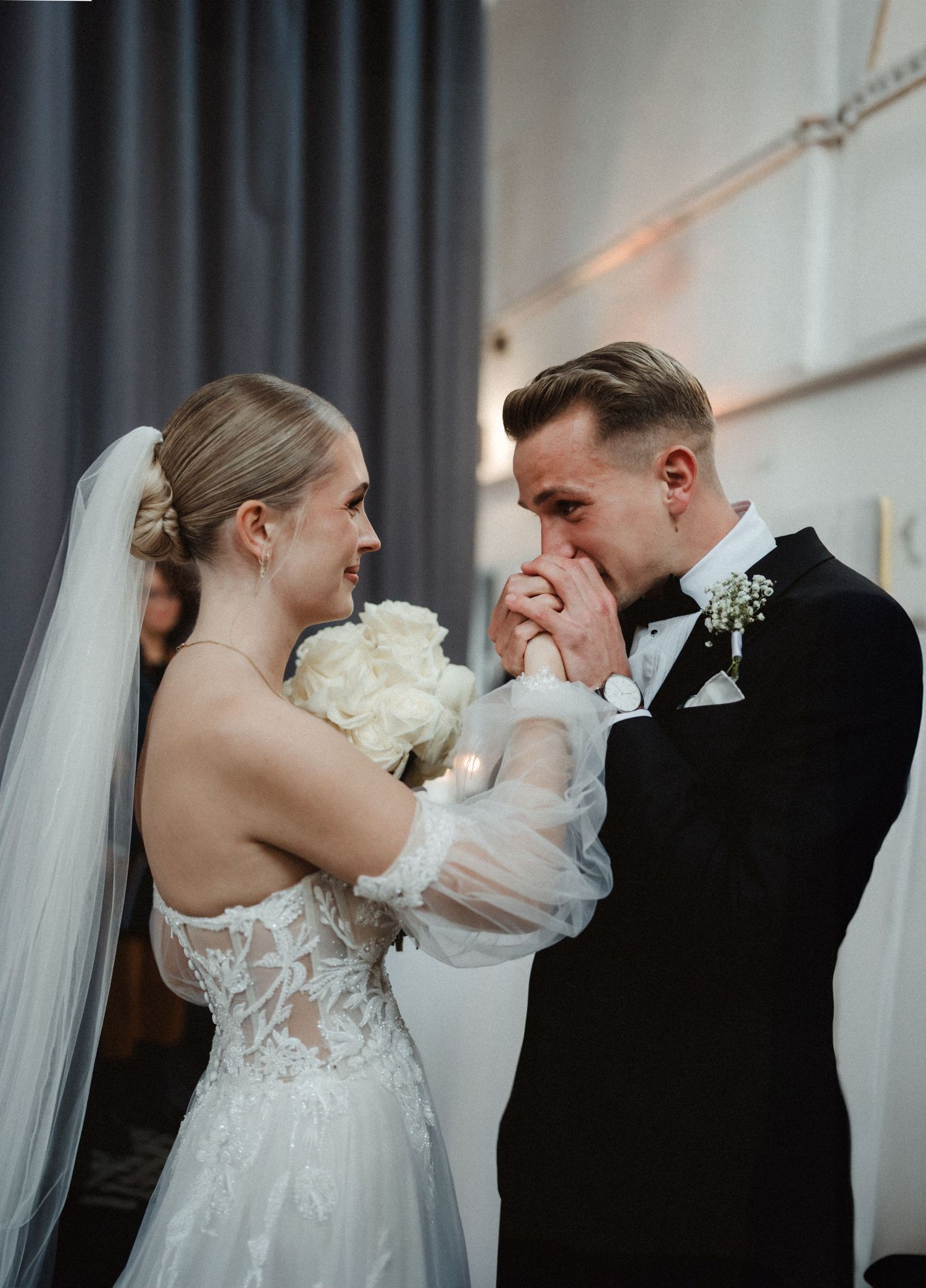 Emotional wedding moment captured during an intimate indoor ceremony.