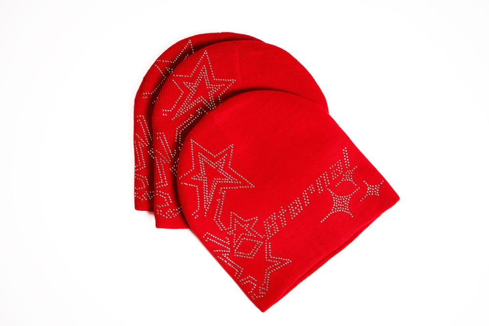 Product photo of folded red beanie — minimalist apparel shot by Timoy B Photography.