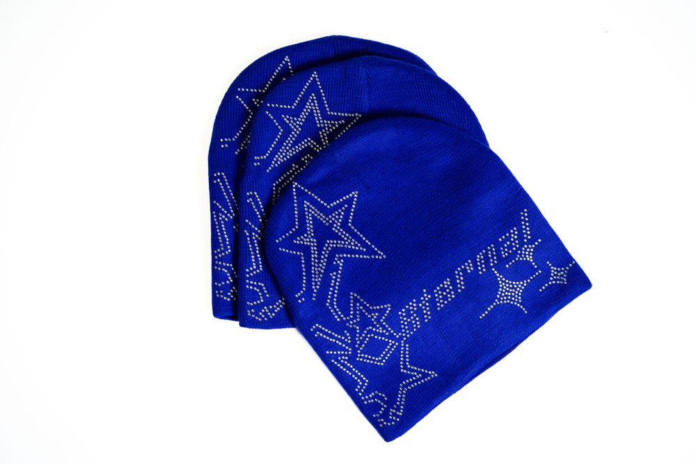Blue embroidered beanie with star design — clean studio product shot by Timoy B Photography.