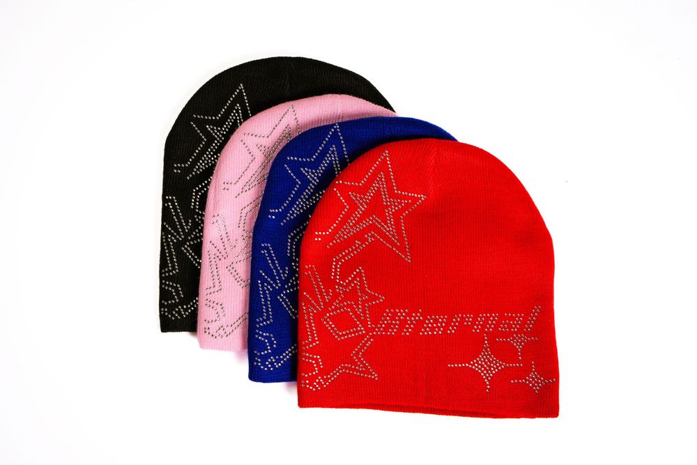 Set of beanies in red, pink, black, and blue — luxury lifestyle flat-lay by Timoy B Photography.