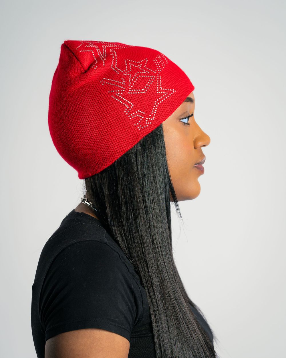Studio portrait of model wearing red beanie — product photo by Timoy B Photography.