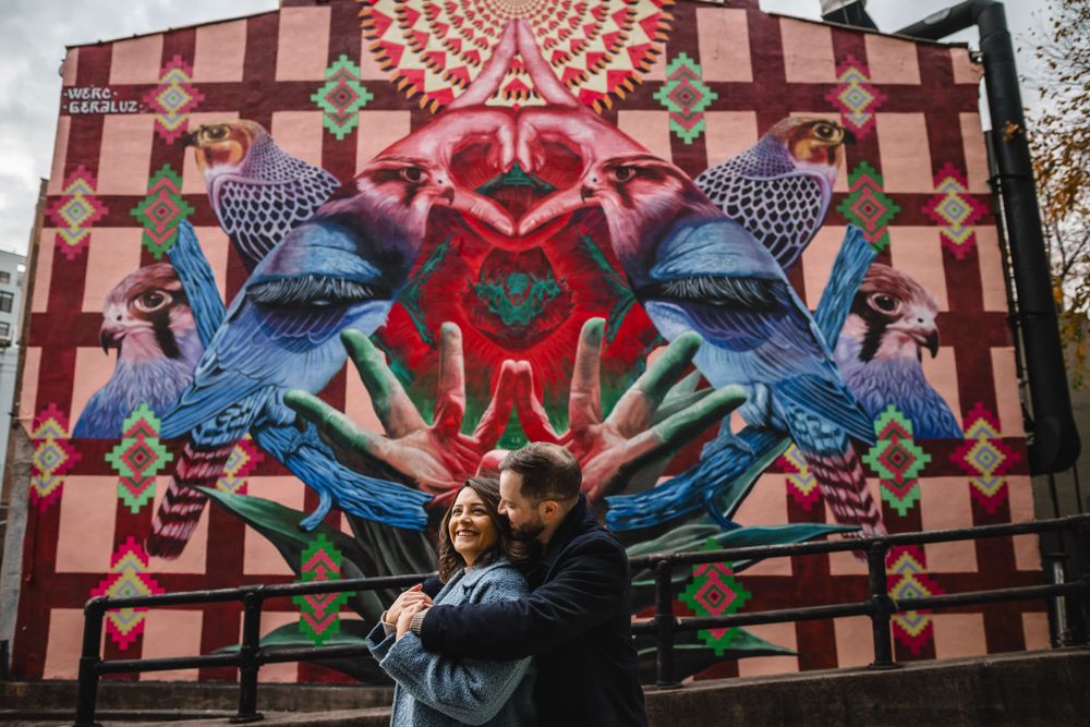 Colorful street art mural with geometric patterns and vibrant blue and red designs.